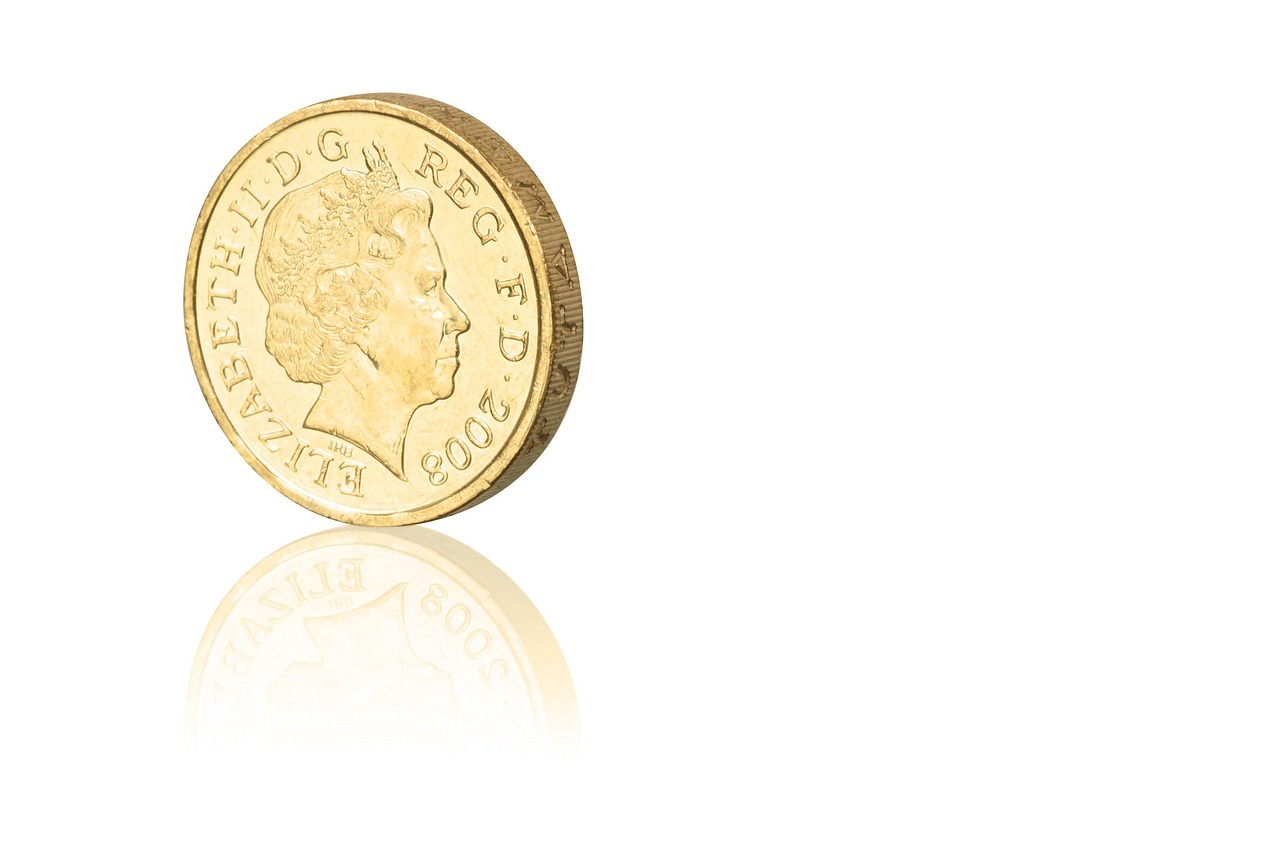 Sterlina d'oro in primo piano con dettagli lucenti, simbolo di valore e collezionismo.