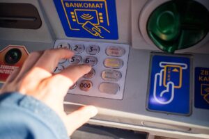 Immagine di un bancomat con avviso sui prelievi superiori a 1.000 euro e segnalazioni automatiche.